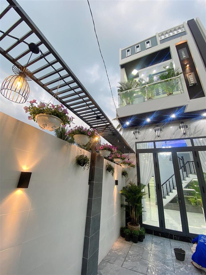 Bán nhà lầu mới hoàn thiện nhà có 4 p ngủ sân đậu được oto 7 chỗ nhà nhánh đ huỳnh thị nở