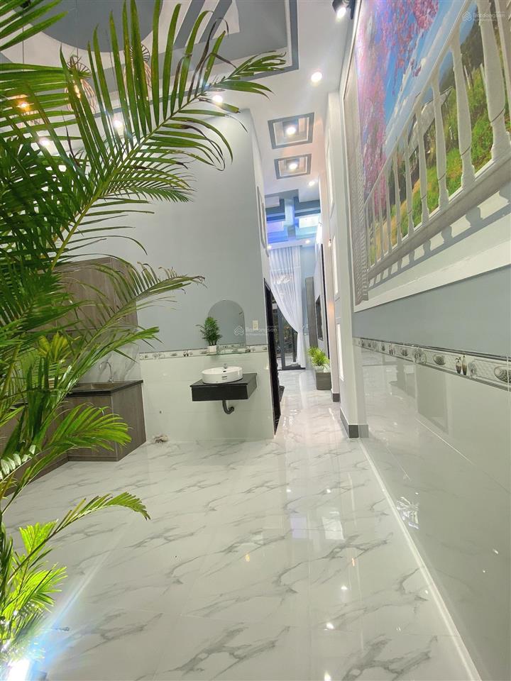 Bán nhà lầu mới hoàn thiện nhà có 4 p ngủ sân đậu được oto 7 chỗ nhà nhánh đ huỳnh thị nở